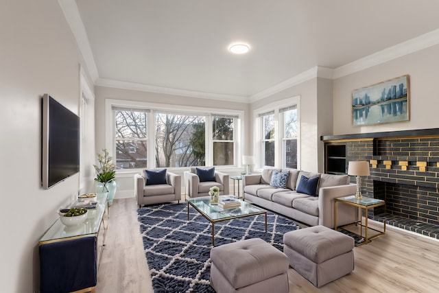 living room with a brick fireplace, wood-type flooring, and ornamental molding