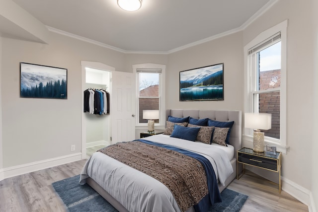 bedroom with light wood-type flooring and crown molding