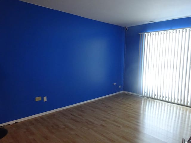 spare room with hardwood / wood-style flooring