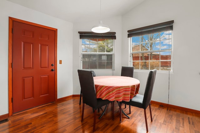 dining room with baseboards, a wealth of natural light, and wood finished floors