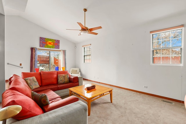 carpeted living area with lofted ceiling, visible vents, ceiling fan, and baseboards