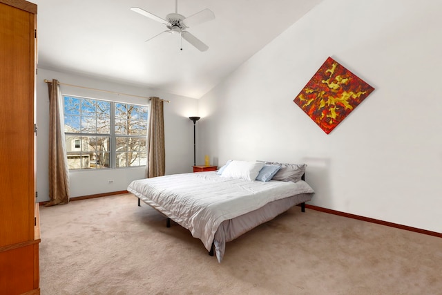 bedroom with light carpet, vaulted ceiling, baseboards, and ceiling fan