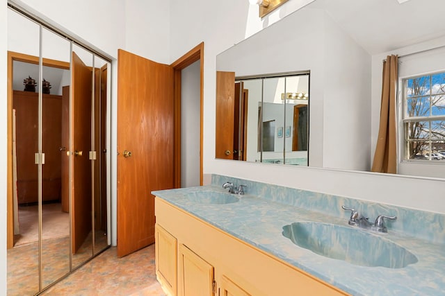 bathroom with lofted ceiling, double vanity, and a sink