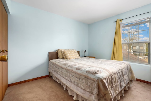 carpeted bedroom with baseboards