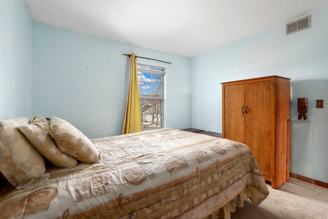 bedroom featuring visible vents and light carpet