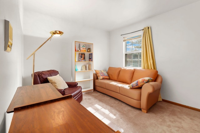 living area featuring baseboards and light colored carpet