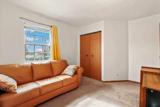 carpeted living room with baseboards