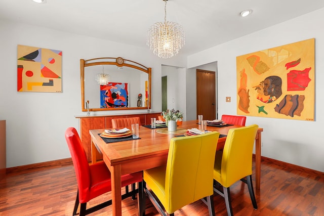 dining area featuring an inviting chandelier, baseboards, wood finished floors, and recessed lighting