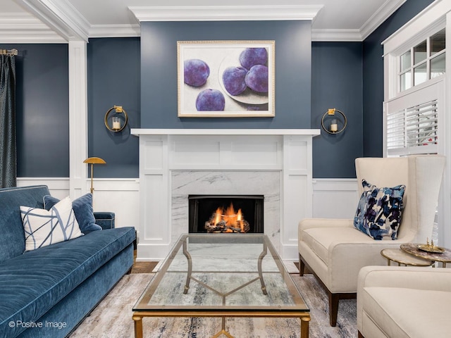 living room featuring crown molding, a premium fireplace, and hardwood / wood-style flooring