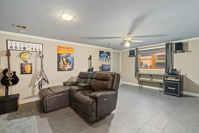 tiled home theater room with visible vents, ornamental molding, a ceiling fan, and baseboards