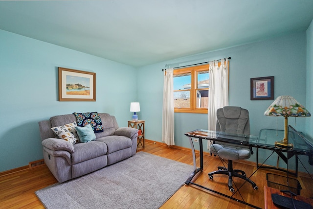 office space featuring hardwood / wood-style flooring, baseboards, and visible vents