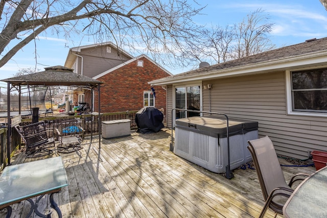 deck with a gazebo, area for grilling, and a hot tub