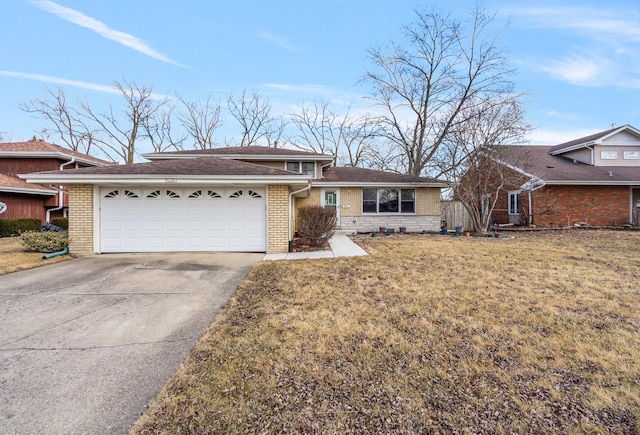 view of front of house featuring concrete driveway, brick siding, and a front yard