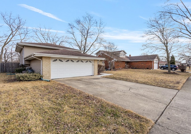 view of front of home with concrete driveway, brick siding, a front lawn, and an attached garage