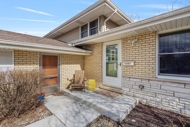 view of exterior entry with brick siding