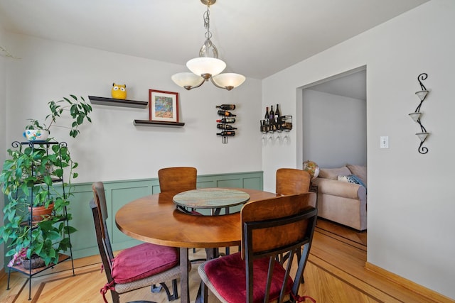 dining area with a chandelier and light wood finished floors