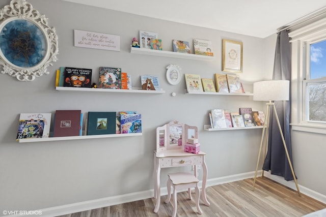 game room with wood finished floors and baseboards