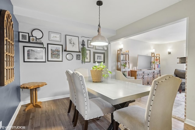 dining area with wood finished floors and baseboards