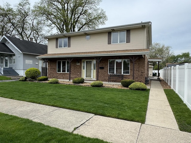 view of front of house with a front yard and covered porch