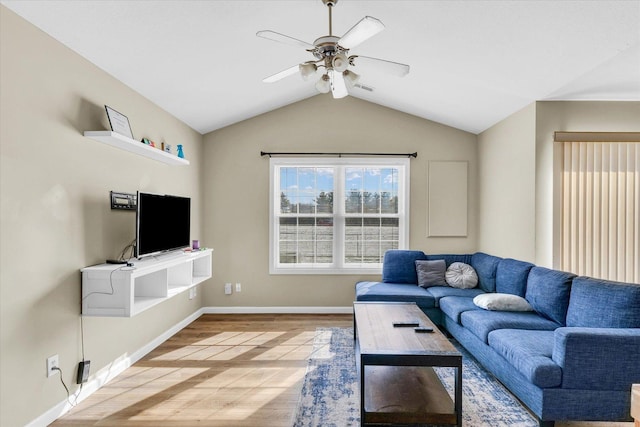 living room featuring hardwood / wood-style flooring, vaulted ceiling, and ceiling fan