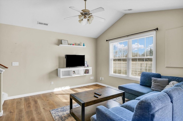 living room featuring lofted ceiling, light hardwood / wood-style flooring, and ceiling fan