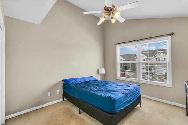 bedroom featuring ceiling fan, lofted ceiling, and light carpet