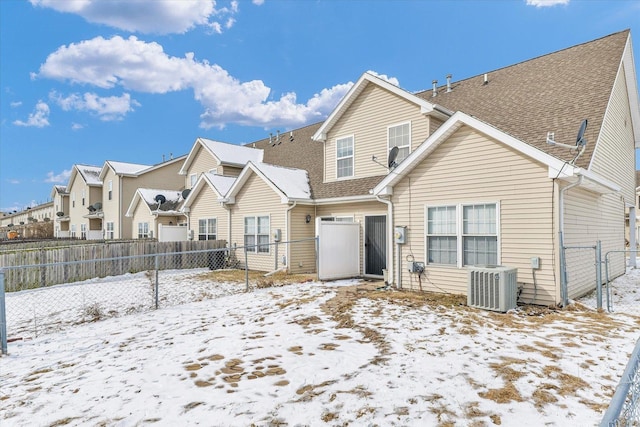 snow covered property featuring cooling unit