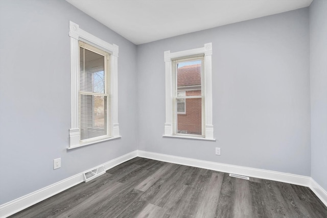 spare room with dark hardwood / wood-style flooring
