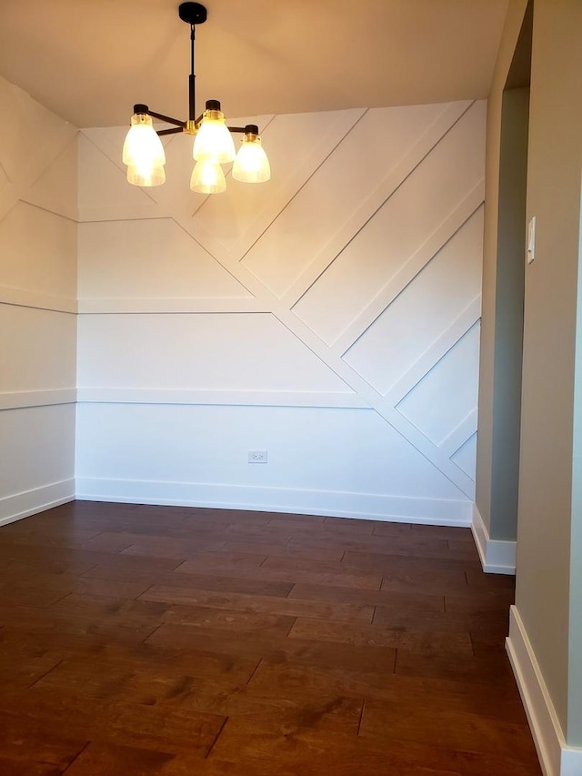 interior space with dark wood-type flooring and a chandelier