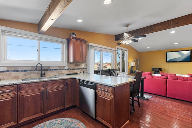 kitchen featuring tasteful backsplash, dishwasher, dark wood-style flooring, a peninsula, and a sink