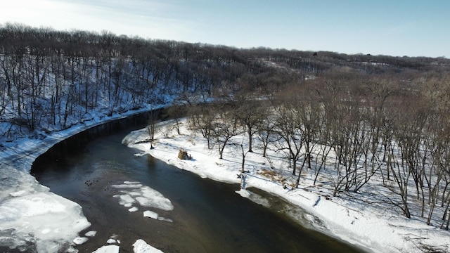 snowy aerial view featuring a water view