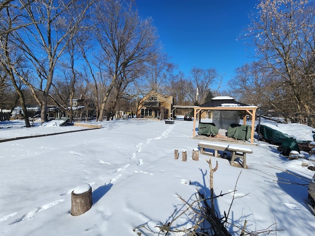 snowy yard featuring a gazebo