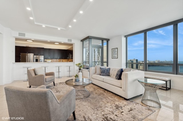 living room with a water view and plenty of natural light