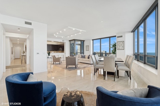 living room featuring floor to ceiling windows