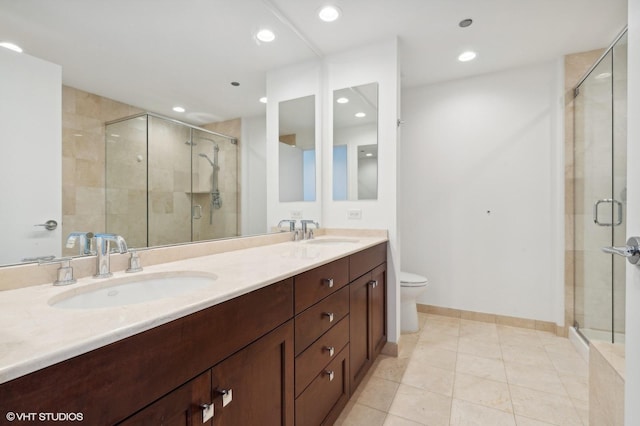 bathroom with walk in shower, tile patterned floors, vanity, and toilet