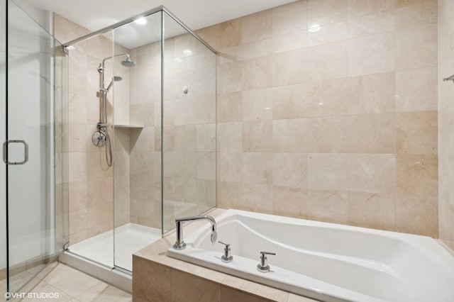 bathroom with tile patterned flooring and separate shower and tub