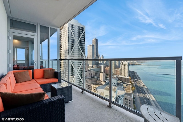 balcony with an outdoor living space and a water view