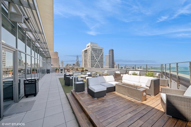 deck featuring an outdoor living space and a water view