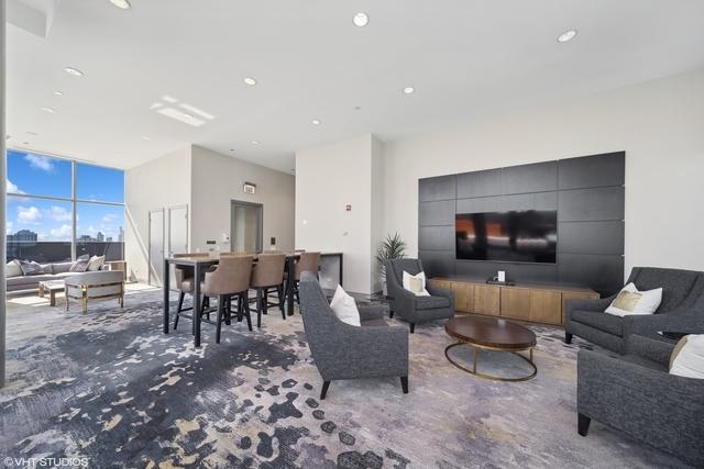 living room with a wall of windows and carpet flooring