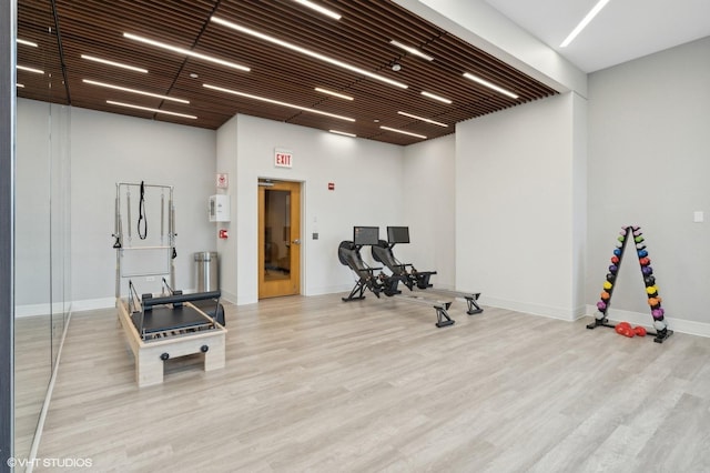 exercise room featuring light wood-type flooring