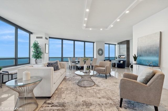 living room featuring floor to ceiling windows and a water view