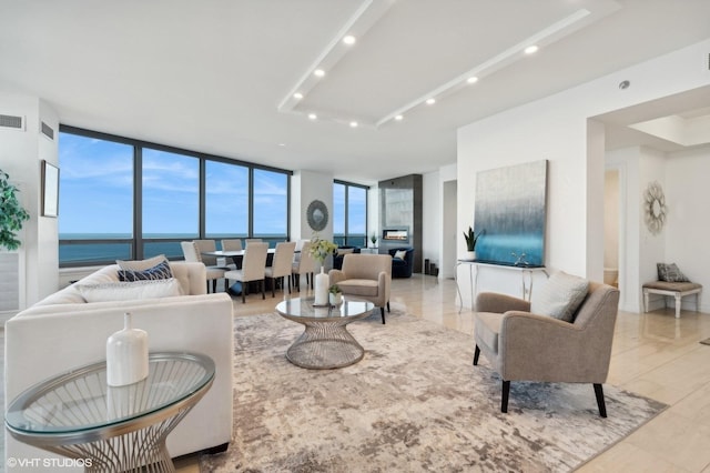 living room featuring a water view and a wall of windows