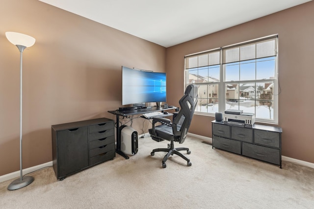 office area featuring baseboards and light colored carpet