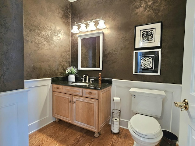 bathroom with vanity, wood-type flooring, and toilet