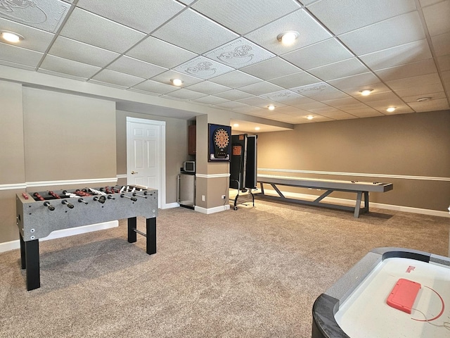 recreation room featuring carpet and a paneled ceiling