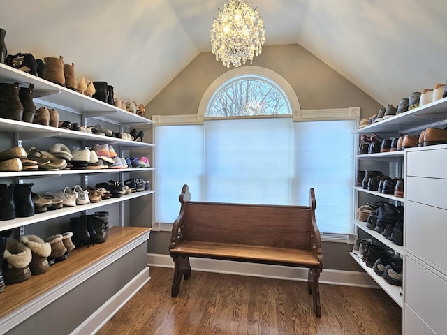 living area with lofted ceiling, dark hardwood / wood-style floors, and a notable chandelier