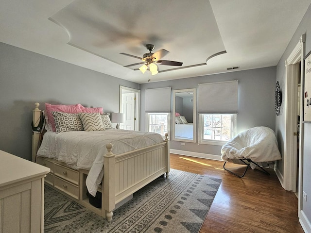 bedroom featuring dark hardwood / wood-style floors and ceiling fan