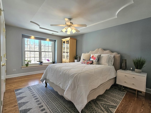 bedroom with dark hardwood / wood-style floors and ceiling fan