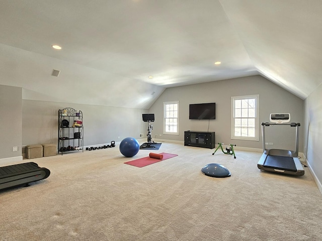 workout room featuring vaulted ceiling and light colored carpet