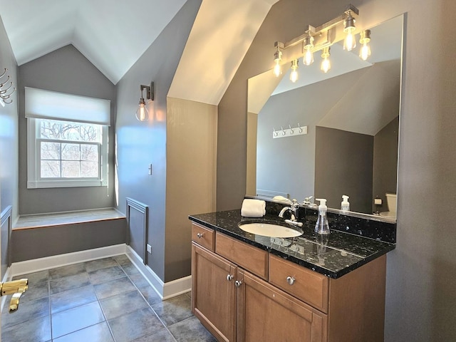 bathroom with vanity, lofted ceiling, and tile patterned floors